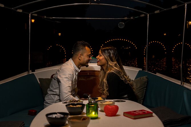 Amsterdam: Private Romantic Evening Canal Cruise + Bubbles/Snacks - Skinny Bridge lit over the Amstel