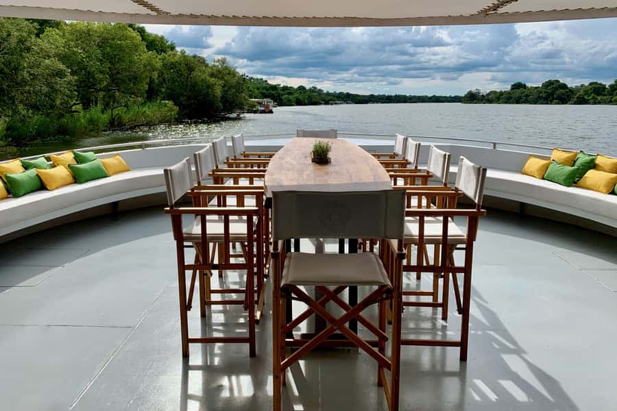 Luxury Sunset Dinner Cruise with 4-Course Meal - Sunset, distant spray, and open river views