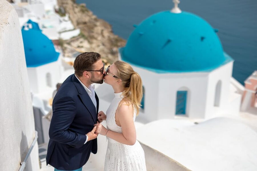 A couple photographed on an empty lane above the caldera in Oia