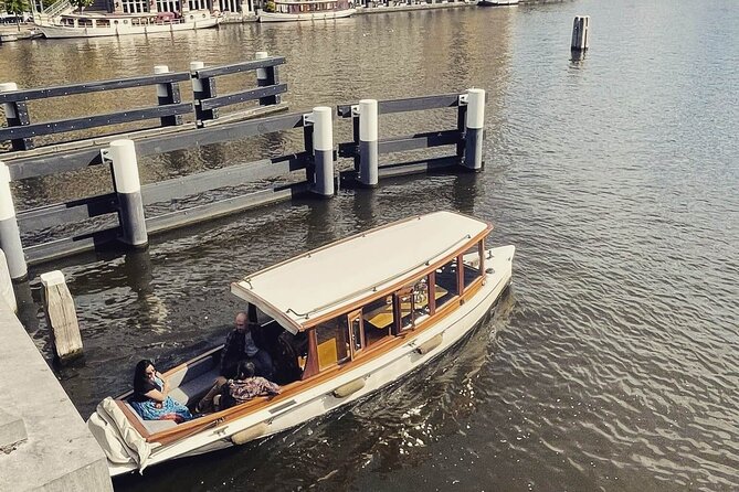 Romantic Private Boat Tour Amsterdam 90min incl welcome drink - The Skinny Bridge under evening lights