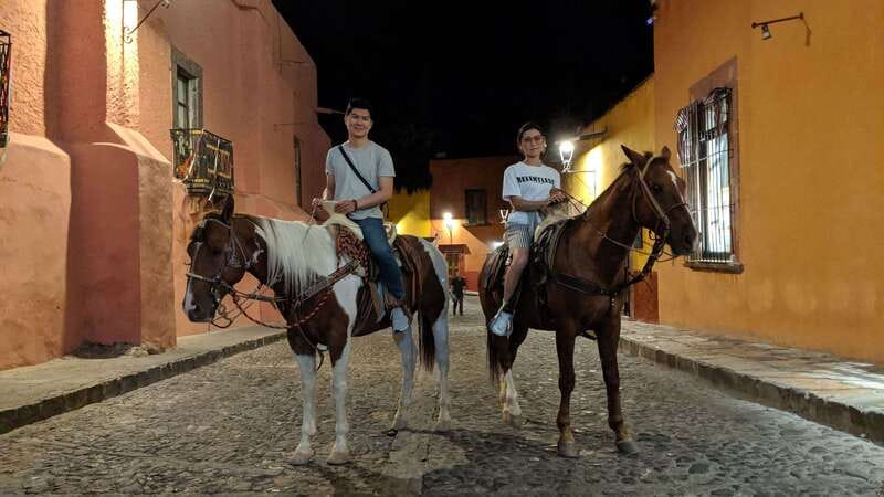 San Miguel: Romantic Horseback Riding at Sunset - Entering Colonia San Antonio after dark